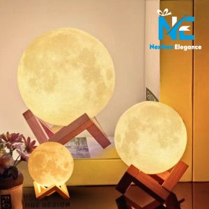Three glowing moon lamps of varying sizes on wooden stands, warm lunar glow with NexGen Elegance branding