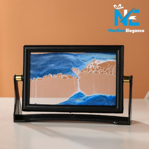 Blue sand motion display in black rectangular frame with dynamic flowing sand patterns, decorative desk art piece