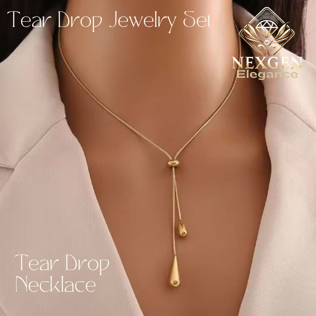 Close-up of a golden tear drop necklace with two dropping pendants, worn by a person in a light-colored blazer, showcasing the necklace's elegant design and fit.