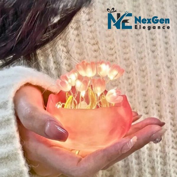 Person holding a small glowing pink tulip pot with bright flowers, wearing knit sweater, NexGen Elegance logo