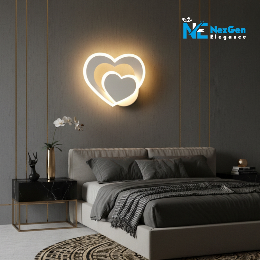 Heart Shape Wall Lamp installed above a modern bed with beige headboard and gray bedding, beside a marble nightstand.