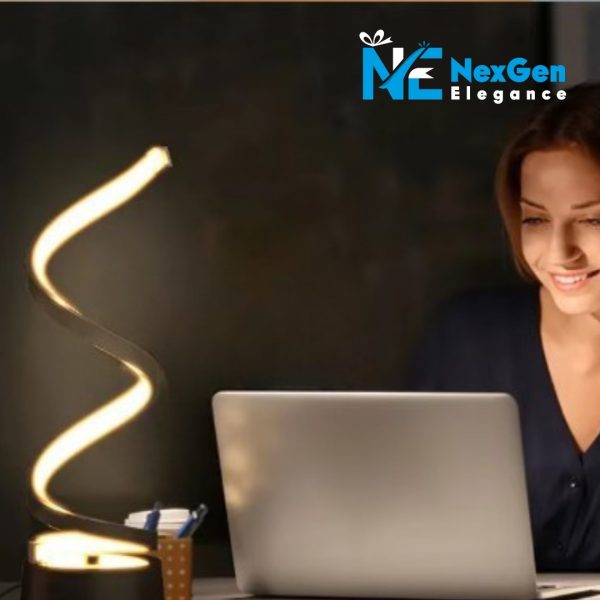 Young woman smiling while working on a laptop with a spiral-shaped LED desk lamp lit on the desk