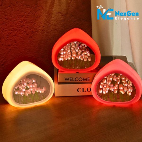 Set of three Love Tulip Night Lights on wooden surface. Colors: pale yellow, bright red, bright pink. Glowing pink and white tulip LEDs inside, warm ambiance, books in background.