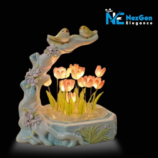 Ceramic night light with two yellow birds on a branch over glowing pink tulip flowers in a white base, decorative LED lamp for bedroom or gift