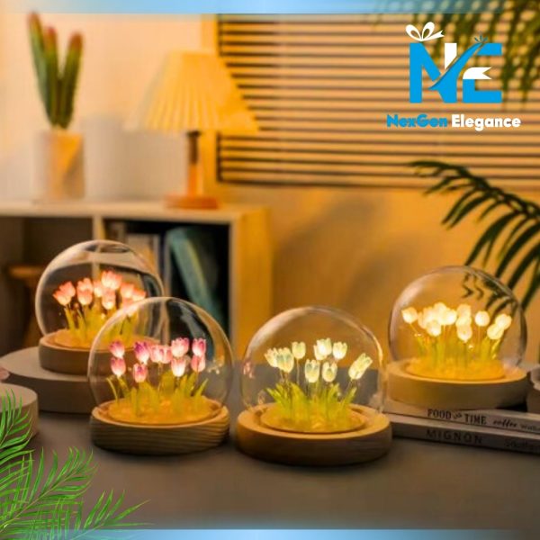 Four glowing tulip LED night lights with glass dome and wooden base displayed in a row on desk, showing multiple color options